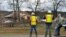 Workers look on as crews restore power in Farmerville, La., Dec. 14, 2022, after a destructive storm system swept through the area.