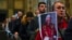 Mourners queue inside St. Peter's Basilica at the Vatican to see Pope Emeritus Benedict XVI lying in state, Jan. 4, 2023.