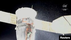 FILE - A stream of particles, which NASA says appears to be liquid and possibly coolant, sprays out of the Soyuz spacecraft on the International Space Station, Dec. 14, 2022, in this still image taken from video. (NASA TV/Handout via Reuters)
