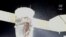 FILE - A stream of particles, which NASA says appears to be liquid and possibly coolant, sprays out of the Soyuz spacecraft on the International Space Station, Dec. 14, 2022, in this still image taken from video. (NASA TV/Handout via Reuters)