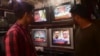 FILE - People watch a TV news broadcast about the nomination of Pakistan's army chief, General Asim Munir, at a market in Karachi, Pakistan, Nov. 24, 2022. Parliament on Nov. 4, 2024, extended the terms of the heads of the armed forces from three years to five years.