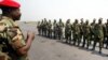 An ECOMOG officer welcomes the contingent of 28 soldiers from Ghana, Benin and Togo, the first elements of a West African peacekeeping force, upon their arrival at the military airport of Abidjan 03 January 2003.