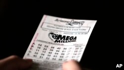 A person holds a Mega Millions lottery ticket in Tempe, Arizona, Dec. 30, 2022.