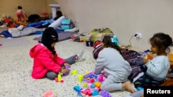 Migrant girls, traveling from Venezuela with their family, play in a shelter near the border between the US and Mexico, after the U.S. Supreme Court said on Tuesday that it will keep Title 42 in force for now, in Ciudad Juarez, Mexico, Dec. 27, 2022. 