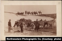 Army contractors and soldiers gathering the dead at the Wounded Knee massacre site, early January, 1891.