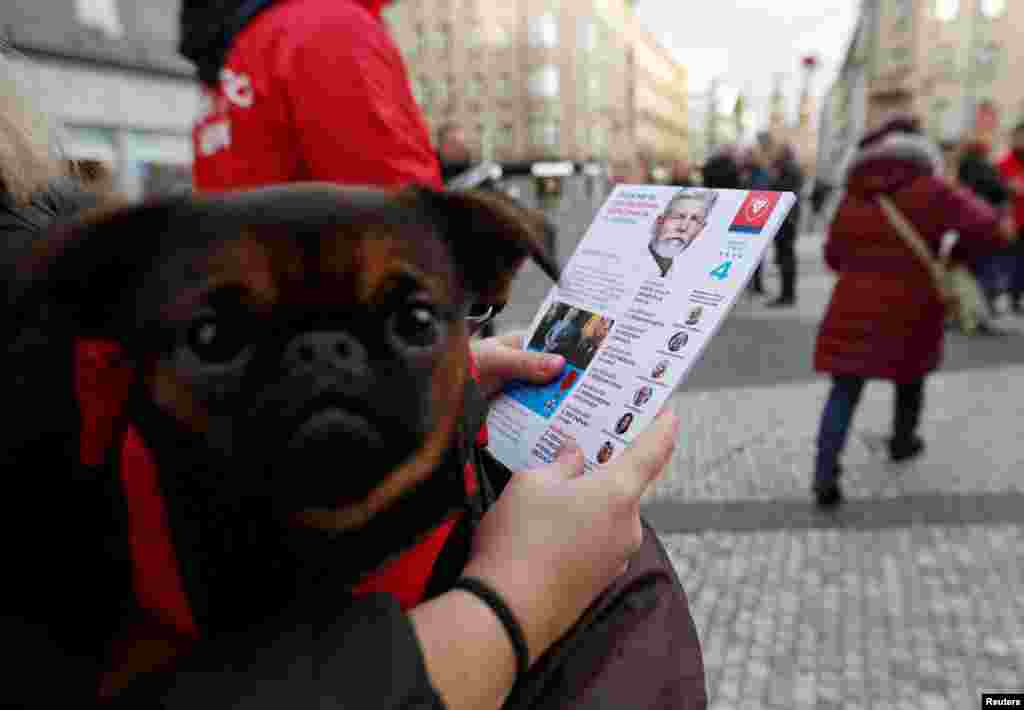 A supporter of presidential candidate and former chairman of the NATO Military Committee and Czech Army General Petr Pavel hands out leaflets, ahead of a direct presidential election that will start on January 13, in Prague, Czech Republic.