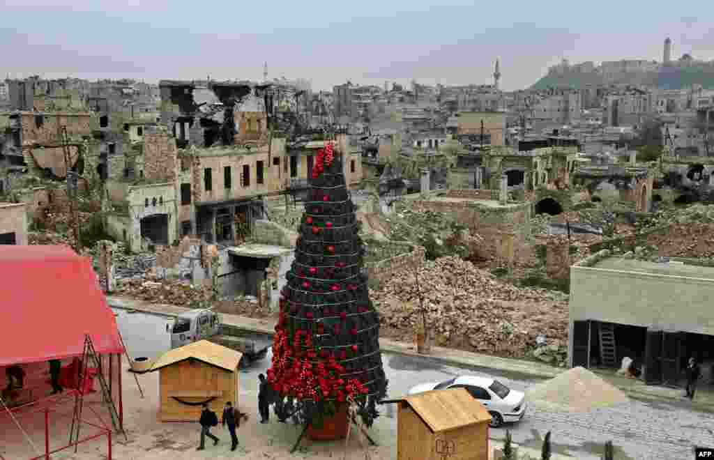 Workers set up a Christmas tree at al-Hatab square, one of the oldest in Syria's northern city of Aleppo, Dec. 12, 2022. 