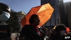 Sex worker Anita Andres (C) (not her real name) chants slogans at a march in solidarity with sex workers set on decriminalizing the trade in Johannesburg on May 27, 2021. 