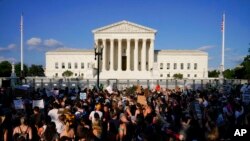 FILE - Protesters fill the street in front of the Supreme Court after the court's decision to overturn Roe v. Wade in Washington, June 24, 2022.