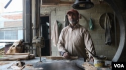 Mohammad Shafi Dar has been working with Model Sports Industries, a cricket bat manufacturing factory, for about 20 years.(Wasim Nabi/VOA)