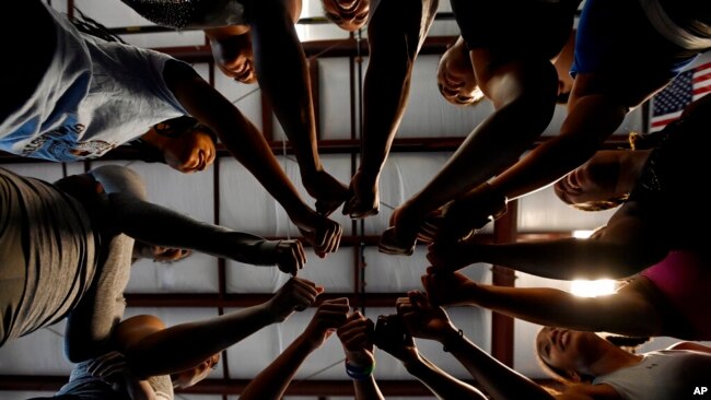 Fisk University gymnastics team gathers in a circle for a cheer during practice at the Nashville Gymnastics Training Center on Dec. 28, 2022, in Nashville, Tenn.