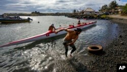 Crew members prepare for a training session for the Hoki Mai challenge, a canoe voyage covering almost 500 kilometers across a stretch of the Pacific Ocean, in Rapa Nui, better known as Easter Island, Nov. 24, 2022.