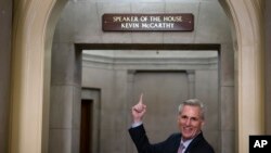 House Speaker Kevin McCarthy of California, gestures towards the newly installed nameplate at his office after he was sworn in as speaker of the 118th Congress in Washington, Jan. 7, 2023.