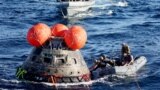 U.S. Navy divers secure NASA's Orion Capsule after it splashed down, Dec. 11, 2022, seen from aboard the U.S.S. Portland in the Pacific Ocean off the coast of Baja California, Mexico. 