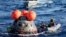 U.S. Navy divers secure NASA's Orion Capsule after it splashed down, Dec. 11, 2022, seen from aboard the U.S.S. Portland in the Pacific Ocean off the coast of Baja California, Mexico. 