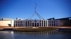 FILE - Tourists walk around the forecourt of Australia's Parliament House in Canberra, Australia, Oct. 16, 2017. 
