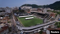 Mourners line up to pay their respects to Brazilian soccer legend Pele as he lies in state on the pitch of his former club Santos' Vila Belmiro Stadium, Santos, Jan. 2, 2023.