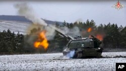 In this handout photo taken from video and released by Russian Defense Ministry Press Service on Jan. 13, 2023, a Russian self-propelled 152.4 mm howitzer Msta fires on a mission at an undisclosed location in Ukraine. 