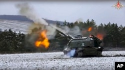 In this handout photo taken from video and released by Russian Defense Ministry Press Service on Jan. 13, 2023, a Russian self-propelled 152.4 mm howitzer Msta fires on a mission at an undisclosed location in Ukraine. 