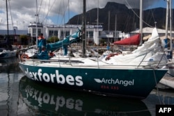 Members of the ArchAngel yacht crew get the boat ready to sail offshore Cape Town on Nov. 13, 2022.