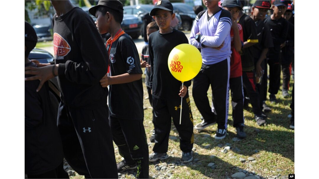 Children queue up for their turn to be vaccinated against poliovirus during a polio immunization campaign at Sigli Town Square in Pidie, Aceh province, Indonesia, Nov. 28, 2022.