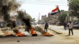 FILE: Tires are set aflame by Sudanese protesters during a demonstration against a tentative deal aimed at ending the crisis provoked by last year's military coup, in the Bashdar district in the south of Sudan's capital Khartoum on December 19, 2022. 