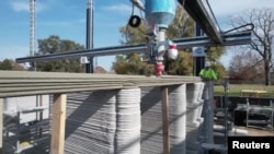 An enormous printer weighing more than 12 tons is creates what is believed to be the first 3D-printed, two-story home in the United States, January 12, 2023. (Reuters from video)
