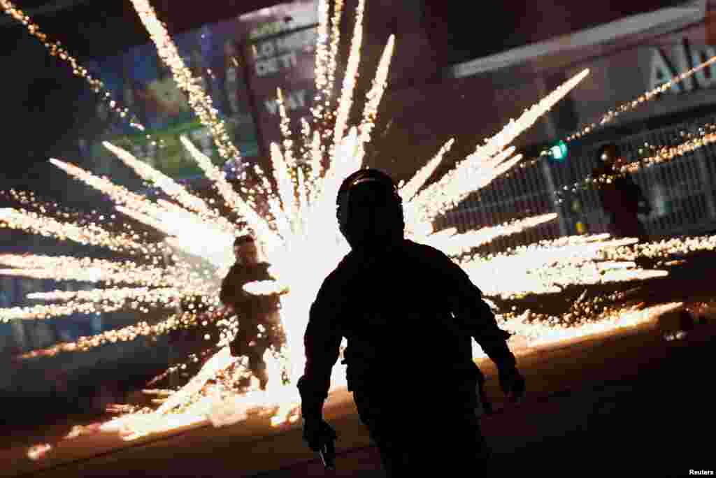 Riot police officers clash with demonstrators as protests following the arrest of Santa Cruz governor and right-wing opposition leader Luis Fernando Camacho over an alleged coup in 2019 continue in Santa Cruz de la Sierra, Bolivia, Jan. 2, 2023. 