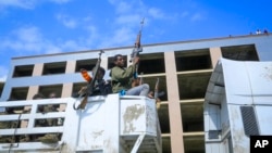 FILE - Armed Tigray forces guard prisoners as they ride through the streets in Mekele, the capital of the Tigray region of northern Ethiopia, Oct. 22, 2021. A new report says detained Tigrayan soldiers were massacred at a camp in southern Ethiopia in November 2021.