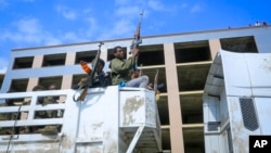 FILE - Armed Tigray forces ride through the streets in open-top trucks, in Mekele, the capital of the Tigray region of northern Ethiopia, Oct. 22, 2021. 