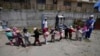 Children play during recess at a government-run daycare where they are fed one meal at lunch time in Catzuqui de Velasco, a rural area without reliable basic services like water and sewage, on the outskirts of Quito, Ecuador, Dec. 1, 2022. 