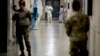 Biological science specialists wear biosafety protective clothing for handling viral diseases at the U.S. Army Medical Research and Development Command at Fort Detrick in Frederick, Maryland, on March 9, 2020. (Andrew Harnik/AP)