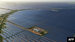 FILE - This photo taken on Oct. 6, 2021 shows solar panels at the site of solar energy projects developer Saurya Urja Company of Rajasthan Limited, at the Bhadla Solar Park in Bhadla, in the northern Indian state of Rajasthan.