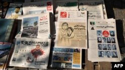 FILE - A kiosk in Tehran on Oct. 30, 2022, displays copies of the Hammihan newspaper, featuring on its cover a headline mentioning the Tehran journalists association's criticism of the detention of two journalists who helped publicize the case of Masha Amini. 