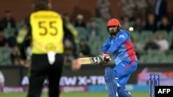 FILE - Afghanistan's Captain Mohammad Nabi plays a shot in the air during the ICC men's Twenty20 World Cup 2022 cricket match between Australia and Afghanistan at Adelaide Oval, in Adelaide, Nov. 4, 2022.