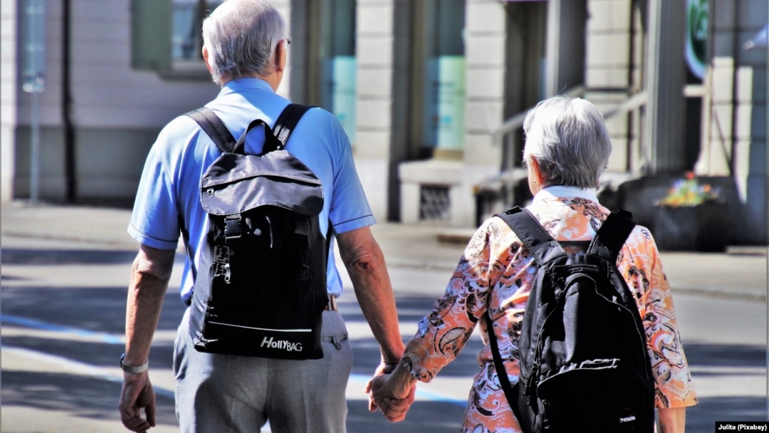 FILE - A couple walks while holding hands in this undated stock photo. A child born in the U.S. in 2021 is expected to live 76.4 years, the lowest figure since 1996, according to data from the U.S. Centers for Disease Control and Prevention.