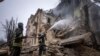 Ukrainian State Emergency Service firefighters work to extinguish a fire at the building which was destroyed by a Russian attack in Kryvyi Rih, Ukraine, Dec. 16, 2022. 