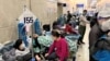 Patients lie on beds in a hallway in the emergency department of Zhongshan Hospital amid the COVID-19 outbreak in Shanghai, Jan. 3, 2023. 