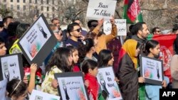 People demonstrate in front of the White House in Washington, Jan. 1, 2023, against the Afghan Taliban regime's ban of higher education for women.