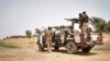 FILE - Malian army soldiers patrol an area next to the river of Djenne in central Mali, Feb. 28, 2020.