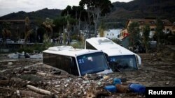 Bus rusak tertimbun puing-puing setelah tanah longsor di pulau wisata Ischia, Italia, 27 November 2022. (Foto: Reuters)
