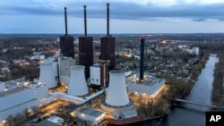 FILE - A cooling tower of the Lichterfelde gas-fired power plant is seen in Berlin, Germany, March 30, 2022. 