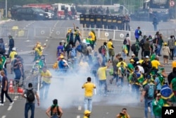 FILE - Supporters of former President Jair Bolsonaro clash with police during a protest outside the Planalto Palace building in Brasilia, Brazil, Jan. 8, 2023.