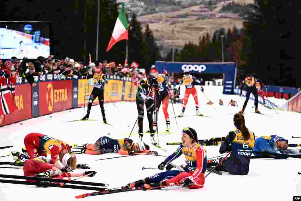 France&#39;s Juliette Ducordeau (Front R) and fellow athletes react after crossing the finish line of the Women&#39;s Mass Start 10 km Free event at the FIS Tour de Ski stage in Val di Fiemme, Italy.