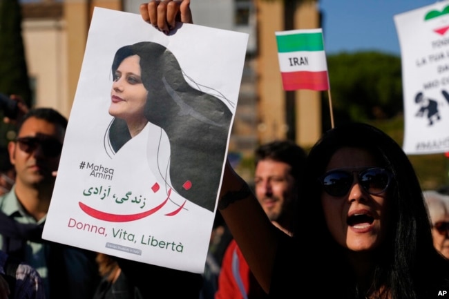 FILE - People protest the death of Mahsa Amini, a woman who died in police custody in Iran, during a rally in central Rome, Oct. 29, 2022.