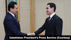 Turkmen President Serdar Berdimuhamedov, right, shakes hands with Sardor Umurzakov, chief of staff of Uzbek President Shavkat Mirziyoyev, Dec. 12, 2022, after the countries reached an agreement to double natural gas imports.