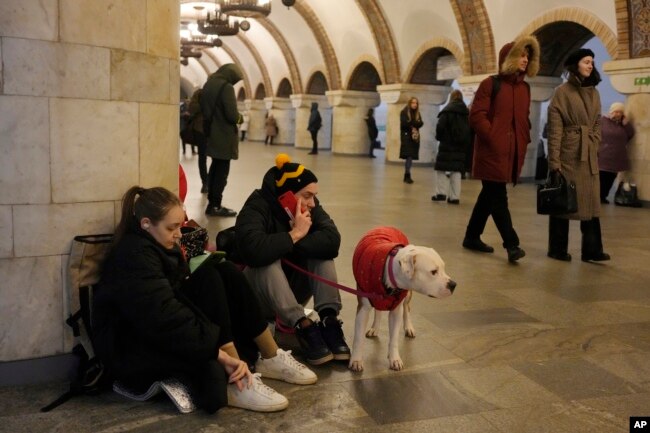 People rest in the subway station being used as a bomb shelter during a rocket attack in Kyiv, Ukraine, Thursday, Dec. 29, 2022. (AP Photo/Efrem Lukatsky)