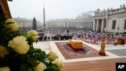 In this image released by the Vatican Media news service, the coffin of late Pope Emeritus Benedict XVI is placed at St. Peter's Square for his funeral mass at the Vatican, Jan. 5, 2023.