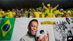 FILE: Brazil fans cheer by a banner celebrating Pele before the World Cup match between Brazil and South Korea at Al Rayyan, Qatar, Dec. 5, 2022.