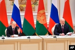 FILE - Russian President Vladimir Putin, left, and Belarusian President Alexander Lukashenko attend a briefing in Minsk, Belarus, Dec. 19, 2022.